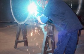 Shop technician welding ductwork
