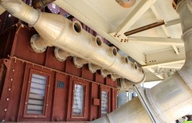 Overhead, oversized industrial ductwork inside a fabrication facility